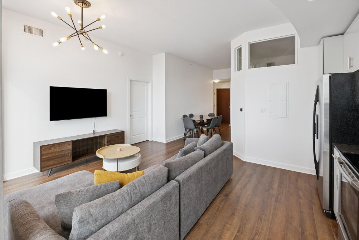 360 Nueces Street, Unit 2704 Austin, TX 78701 - Photo 12 of 40 a living room with furniture and a flat screen tv