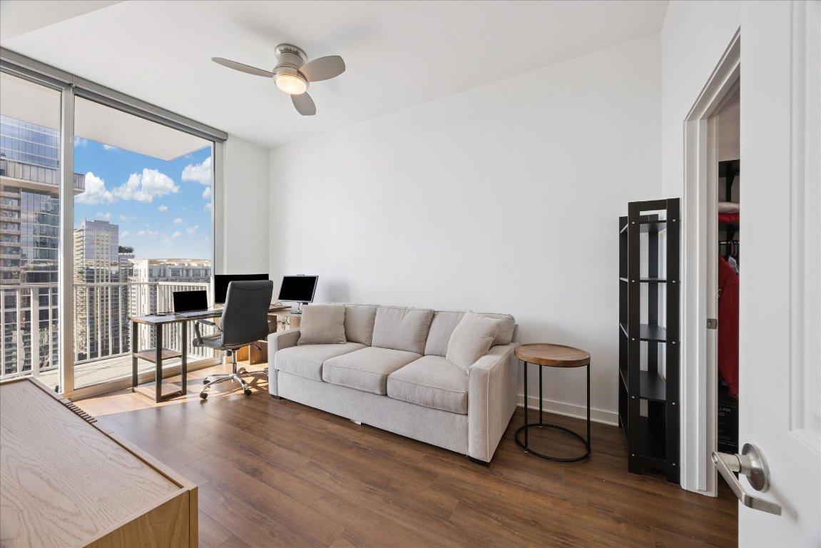 360 Nueces Street, Unit 2704 Austin, TX 78701 - Photo 18 of 40 a living room with furniture and a floor to ceiling window