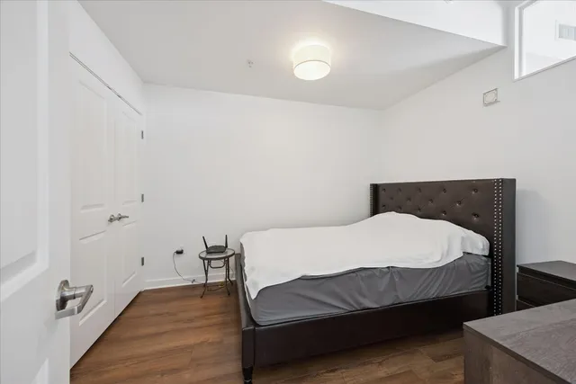 a view of a bedroom with wooden floor