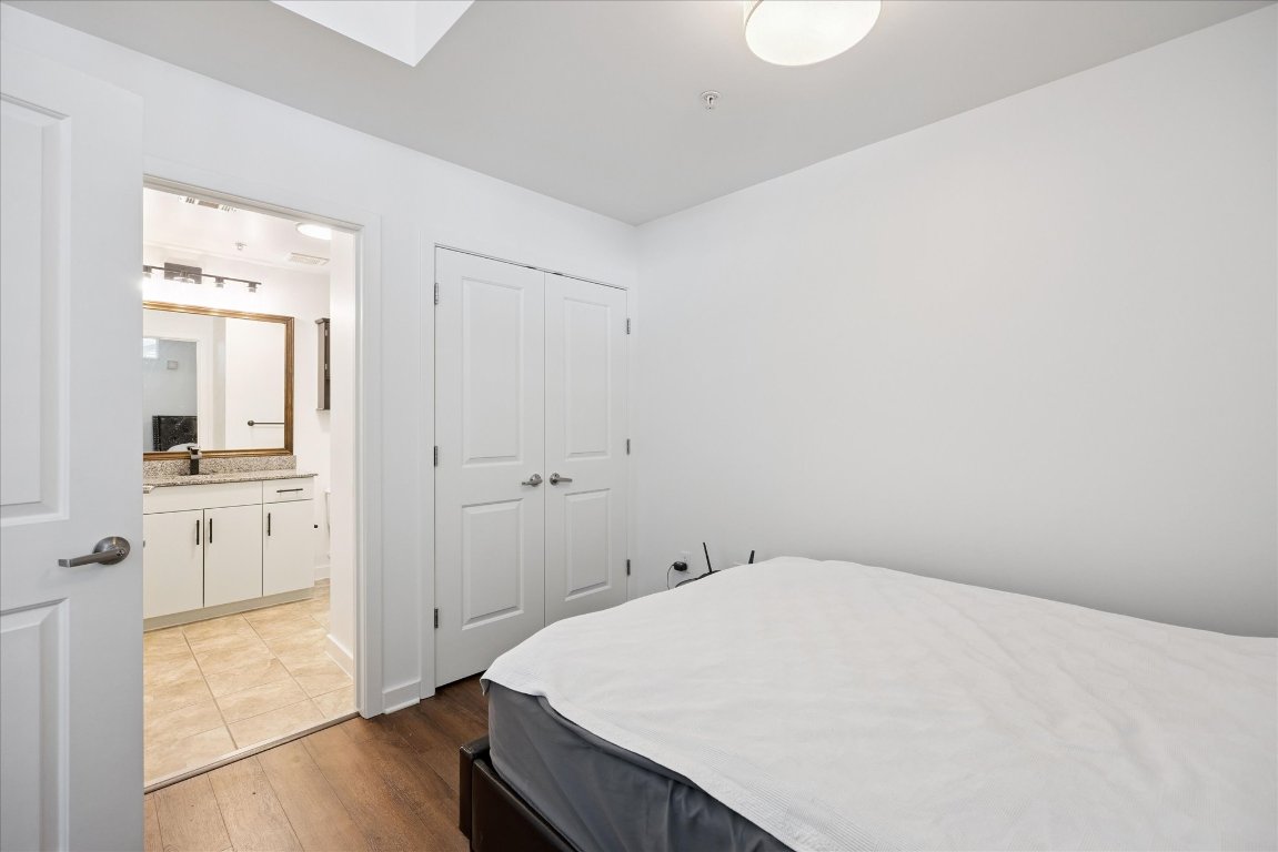 360 Nueces Street, Unit 2704 Austin, TX 78701 - Photo 26 of 40 a view of a bedroom with wooden floor