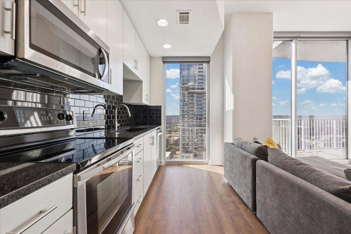 360 Nueces Street, Unit 2704 Austin, TX 78701 - Photo 6 of 40 a kitchen with stainless steel appliances granite countertop a stove and a refrigerator