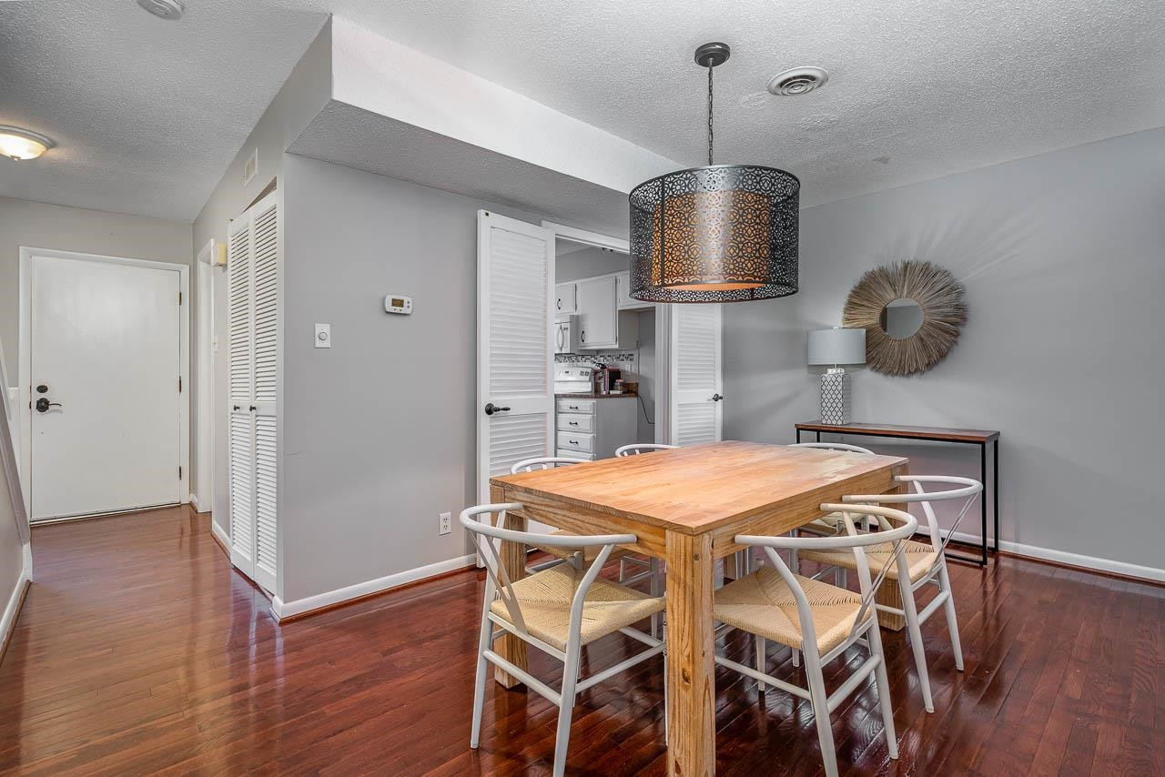 3080 Colony Road, Unit 3080E Durham, NC 27705 - Photo 11 of 31 a dining room with furniture and wooden floor