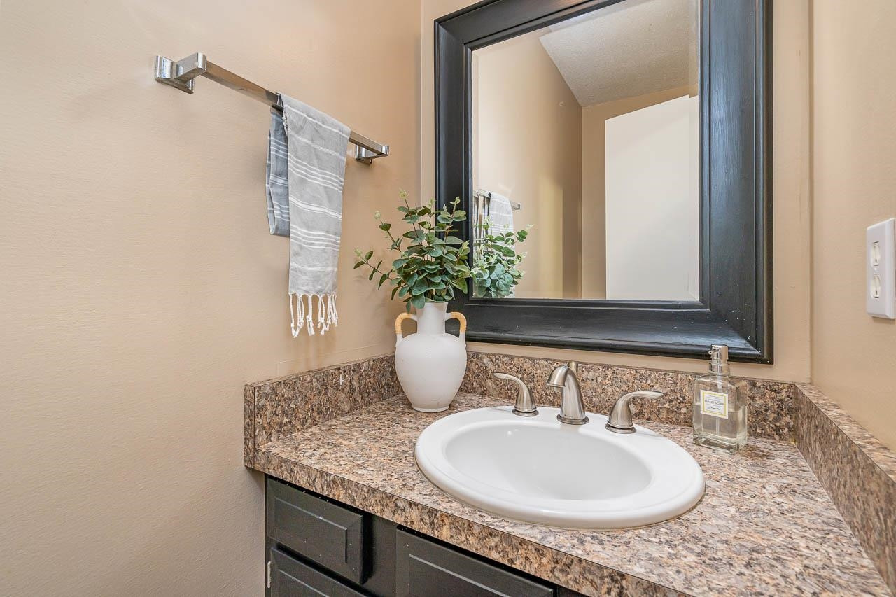3080 Colony Road, Unit 3080E Durham, NC 27705 - Photo 15 of 31 a bathroom with a granite countertop sink and a mirror