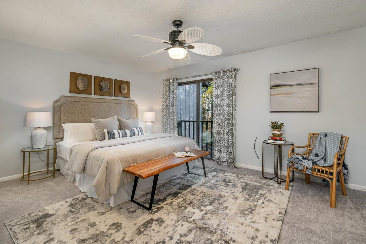 3080 Colony Road, Unit 3080E Durham, NC 27705 - Photo 18 of 31 a bedroom with a bed and a chandelier