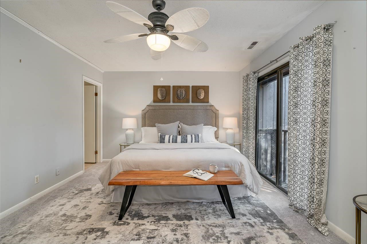 3080 Colony Road, Unit 3080E Durham, NC 27705 - Photo 19 of 31 a bedroom with a bed and a chandelier