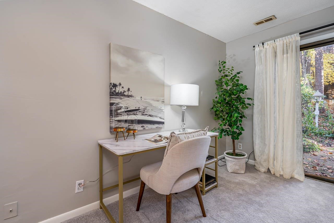 3080 Colony Road, Unit 3080E Durham, NC 27705 - Photo 5 of 31 a workspace with furniture and a potted plant