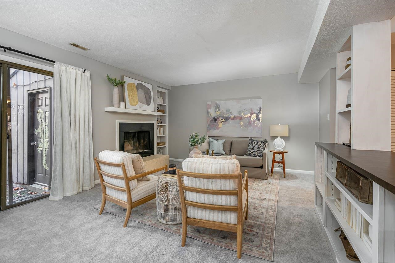 3080 Colony Road, Unit 3080E Durham, NC 27705 - Photo 6 of 31 a living room with furniture and a fireplace