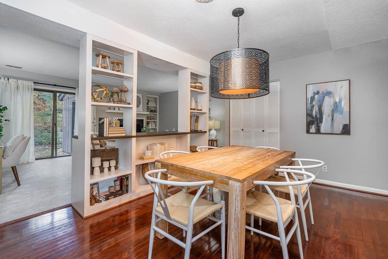 3080 Colony Road, Unit 3080E Durham, NC 27705 - Photo 8 of 31 a dining room with a table and chairs