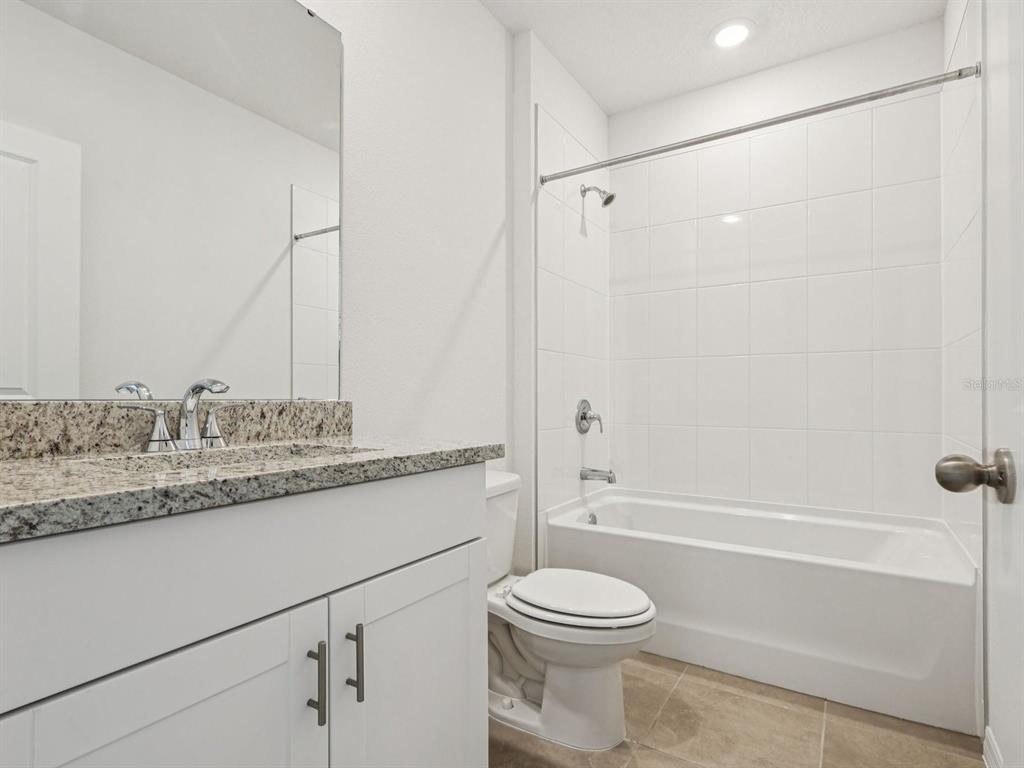 1646 Bark Rdg Drive Auburndale, FL 33823 - Photo 18 of 34 a bathroom with a granite countertop sink a toilet and shower