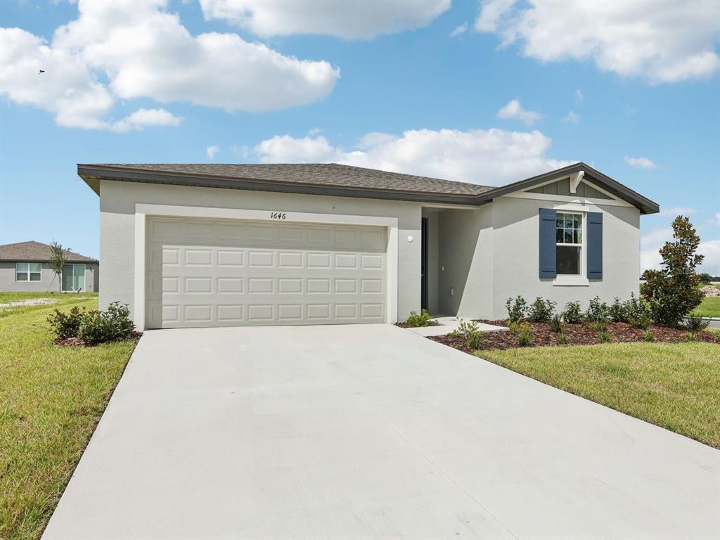 1646 Bark Rdg Drive Auburndale, FL 33823 - Photo 2 of 34 a front view of a house with a yard and garage