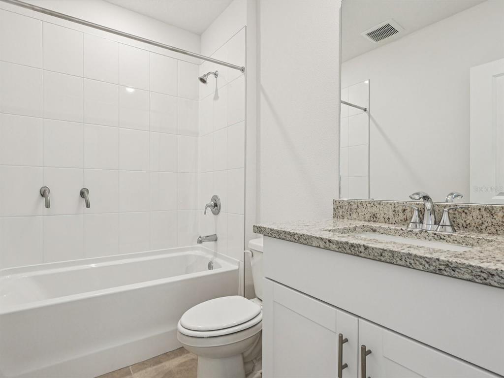 1646 Bark Rdg Drive Auburndale, FL 33823 - Photo 21 of 34 a bathroom with a granite countertop sink toilet and shower