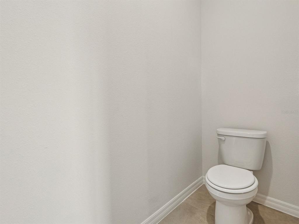 1646 Bark Rdg Drive Auburndale, FL 33823 - Photo 28 of 34 a white toilet sitting next to a white wall