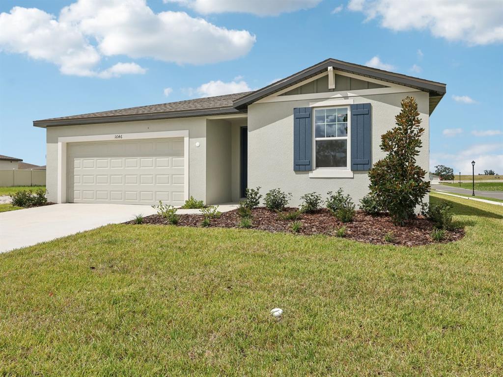 1646 Bark Rdg Drive Auburndale, FL 33823 - Photo 3 of 34 a front view of a house with a yard and garage