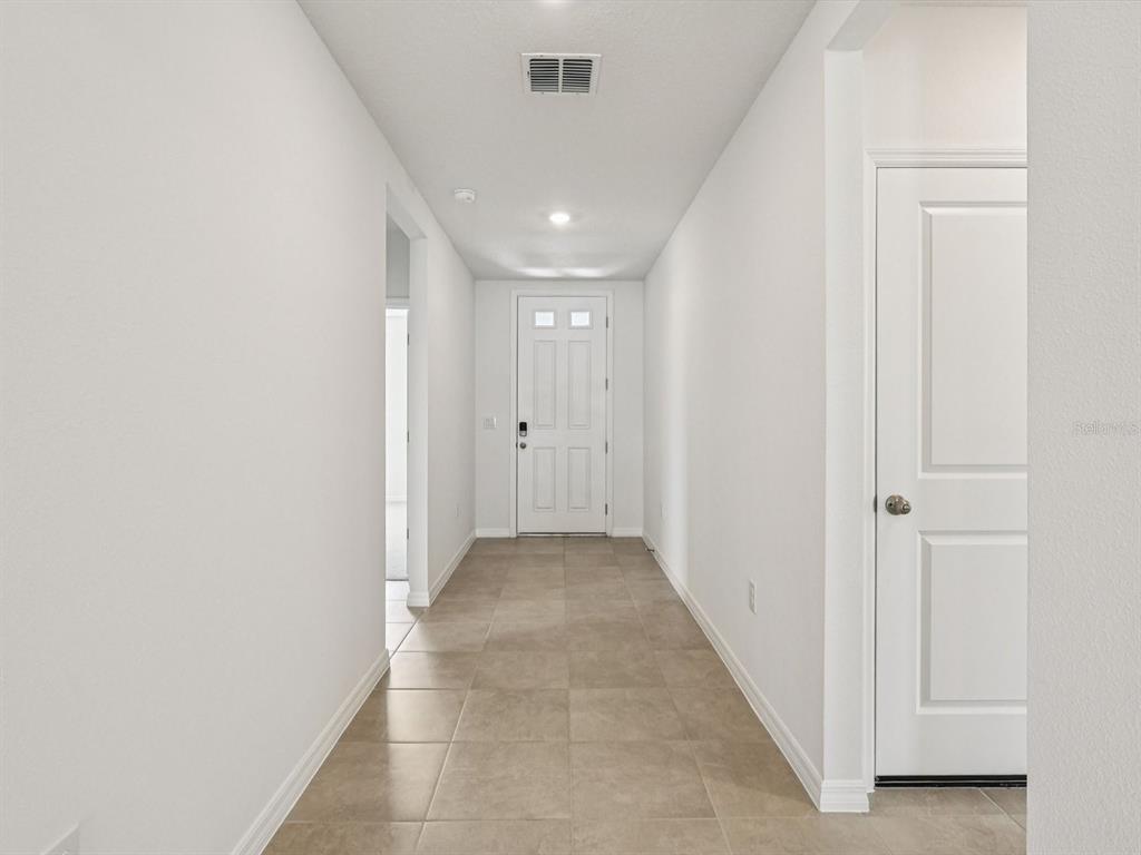 1646 Bark Rdg Drive Auburndale, FL 33823 - Photo 5 of 34 a view of a hallway with wooden floor