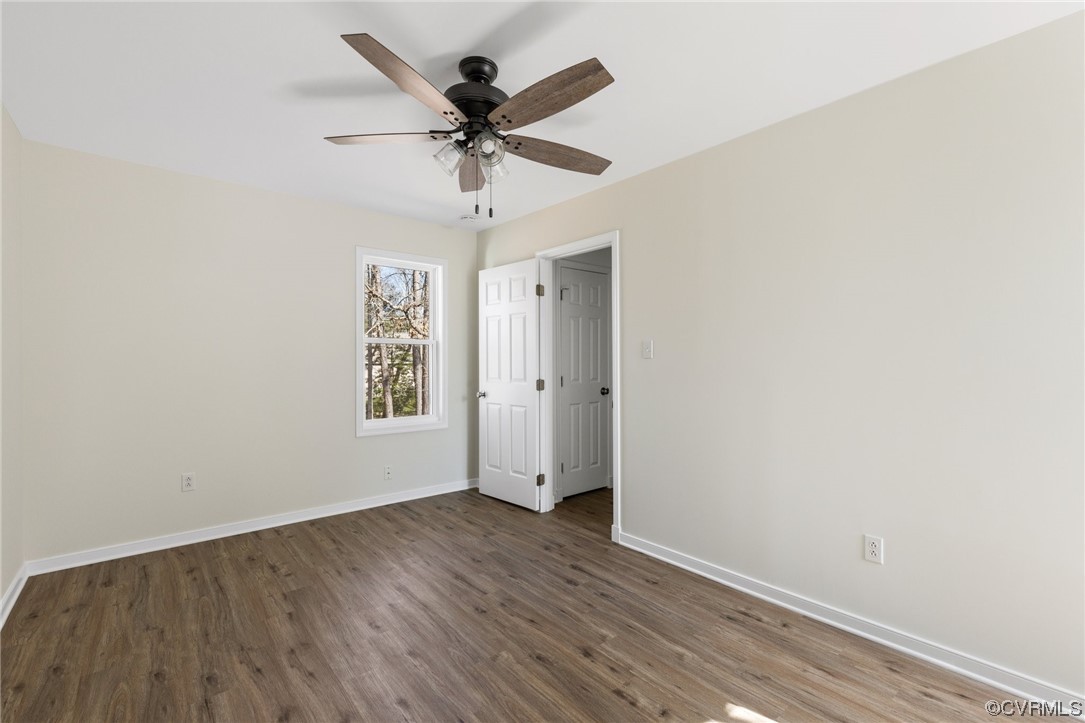 10618 Timberun Road Chesterfield, VA 23832 - Photo 23 of 30 an empty room with wooden floor ceiling fan and windows