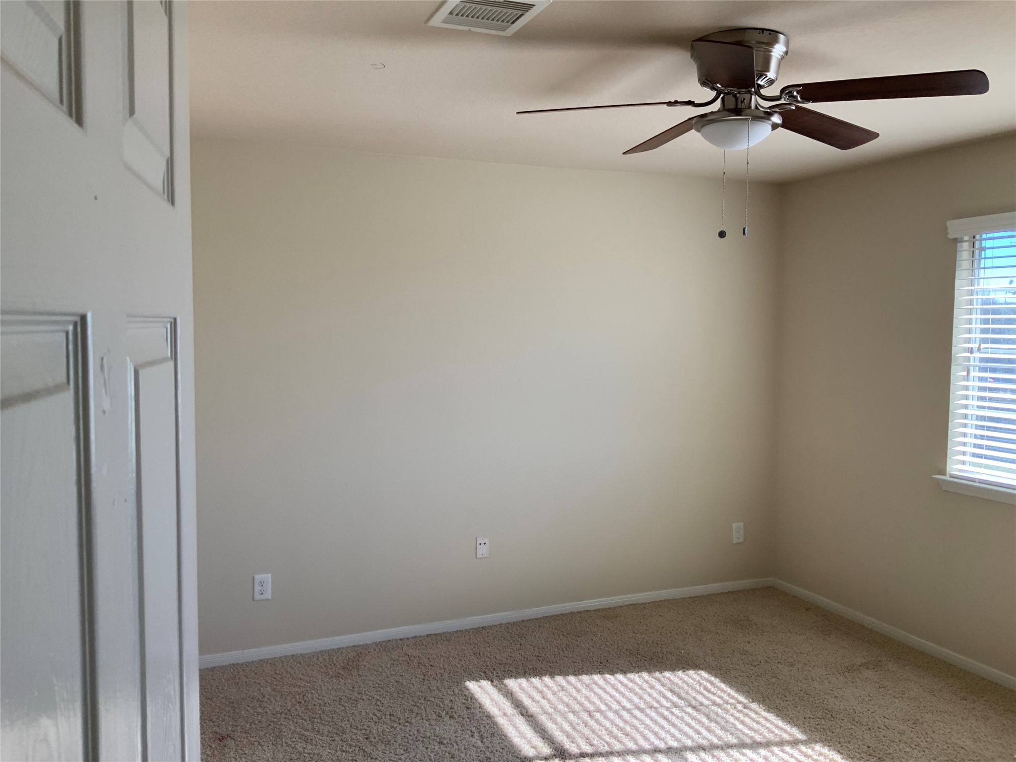 22011 Castle Hawk Trail Richmond, TX 77407 - Photo 15 of 17 an empty room with a window and a ceiling fan