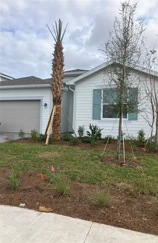a backyard of a house with table and chairs