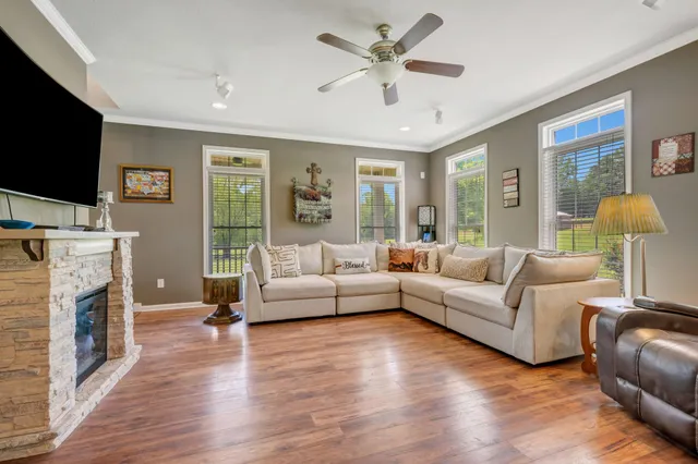 a kitchen with stainless steel appliances granite countertop wooden cabinets a sink and a large window