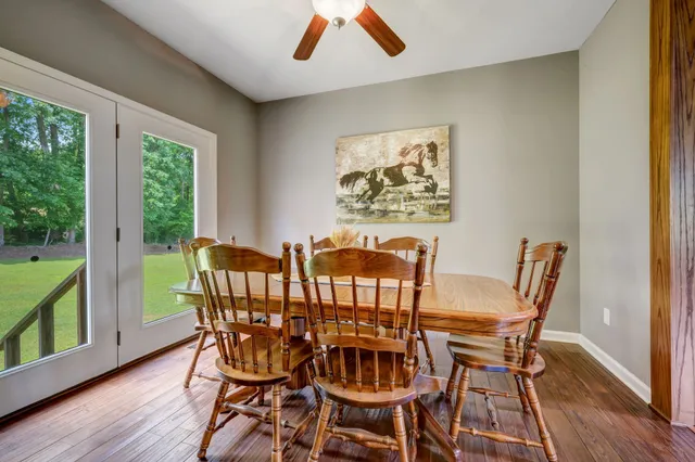 a bedroom with a bed a desk and chair with a bookshelf