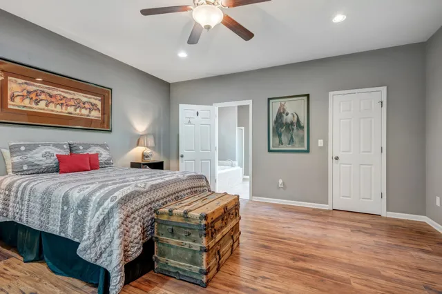 a view of a green field with a house in the background