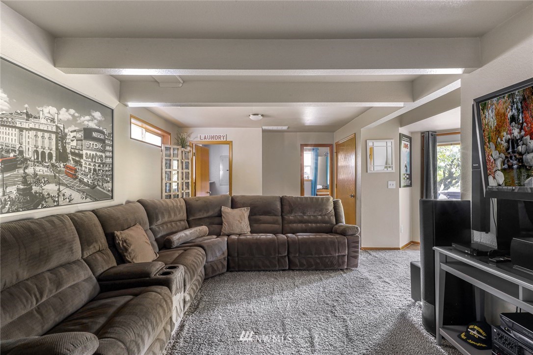 6650 North Star Road Ferndale, WA 98248 - Photo 14 of 40 a living room with furniture a flat screen tv and a large window