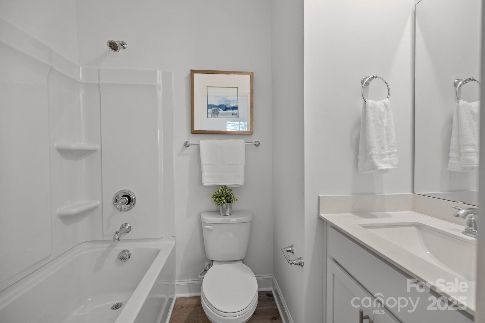 3128 Butler Hl Drive Matthews, NC 28105 - Photo 15 of 24 a bathroom with a granite countertop toilet a sink and bathtub