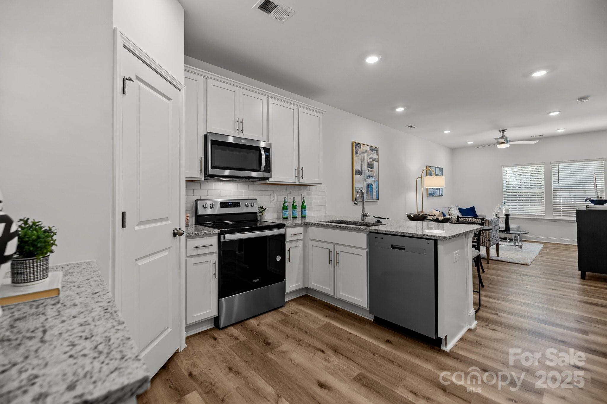 3128 Butler Hl Drive Matthews, NC 28105 - Photo 5 of 24 a kitchen with a sink cabinets and stainless steel appliances