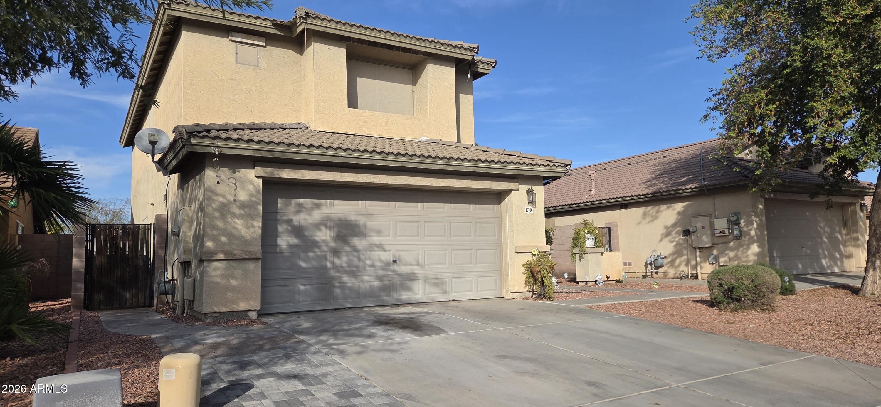 10766 West Del Rio Lane Avondale, AZ 85323 - Photo 2 of 12 a front view of a house with a garage
