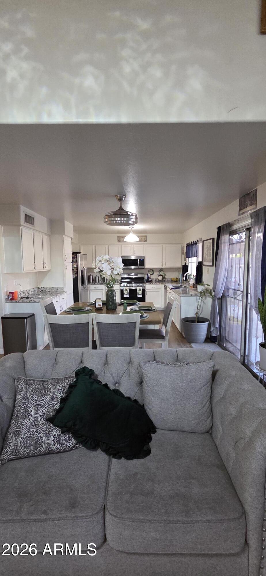10766 West Del Rio Lane Avondale, AZ 85323 - Photo 3 of 12 a large kitchen with stainless steel appliances kitchen island granite countertop a sink and cabinets