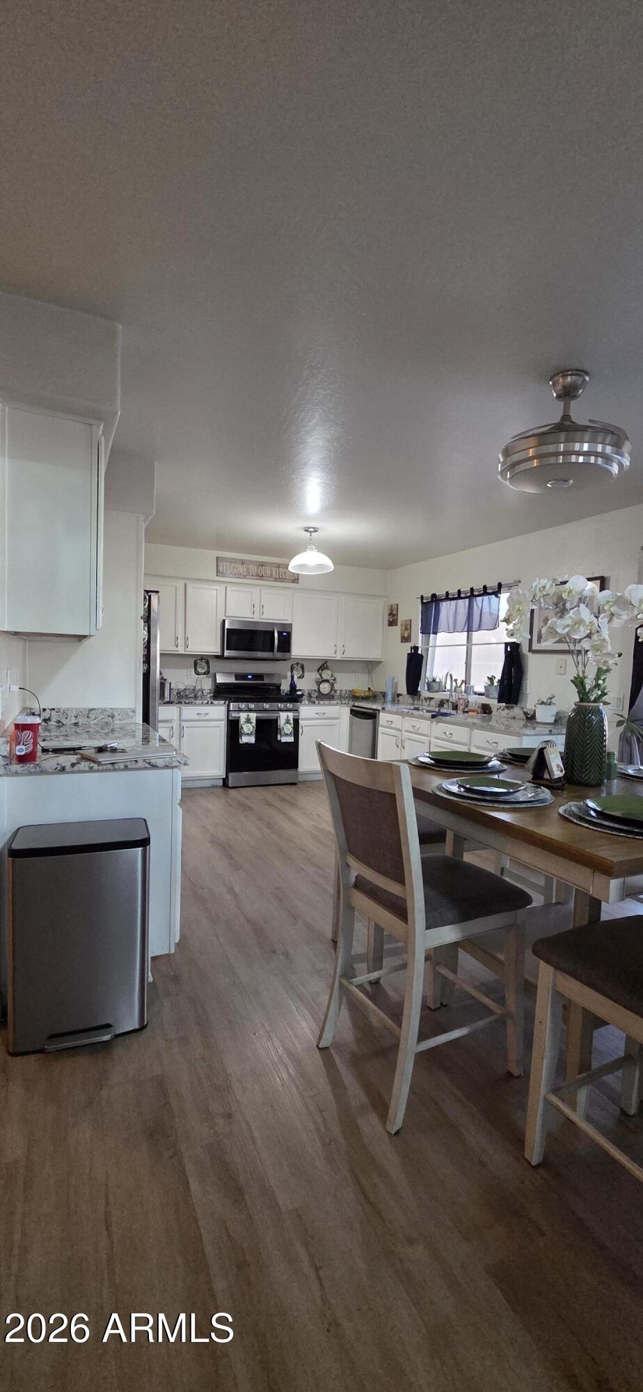 10766 West Del Rio Lane Avondale, AZ 85323 - Photo 4 of 12 a kitchen with a table and chairs in it