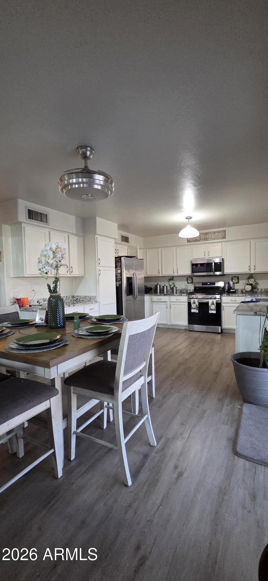 10766 West Del Rio Lane Avondale, AZ 85323 - Photo 5 of 12 a living room with lots of furniture and kitchen view