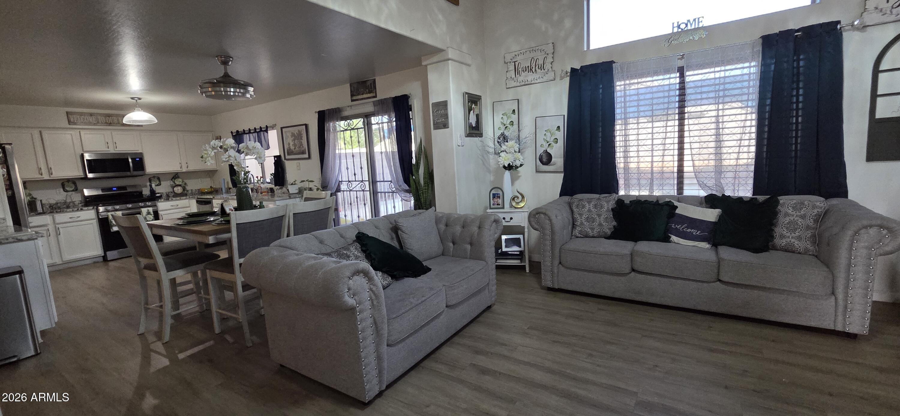 10766 West Del Rio Lane Avondale, AZ 85323 - Photo 6 of 12 a living room with furniture and a large window