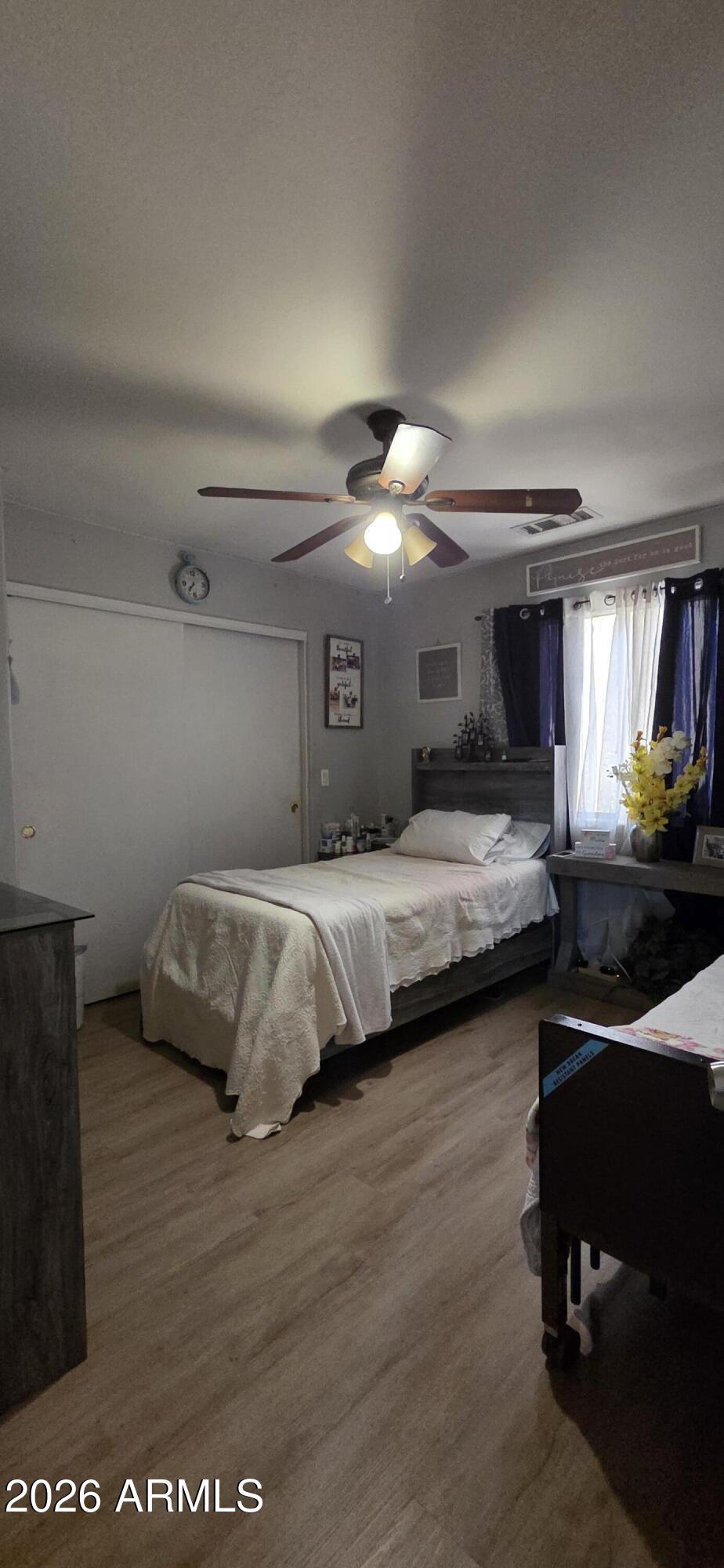 10766 West Del Rio Lane Avondale, AZ 85323 - Photo 8 of 12 a bedroom with a bed and a view of kitchen