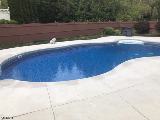 a kitchen with kitchen island granite countertop a sink a counter space appliances and cabinets