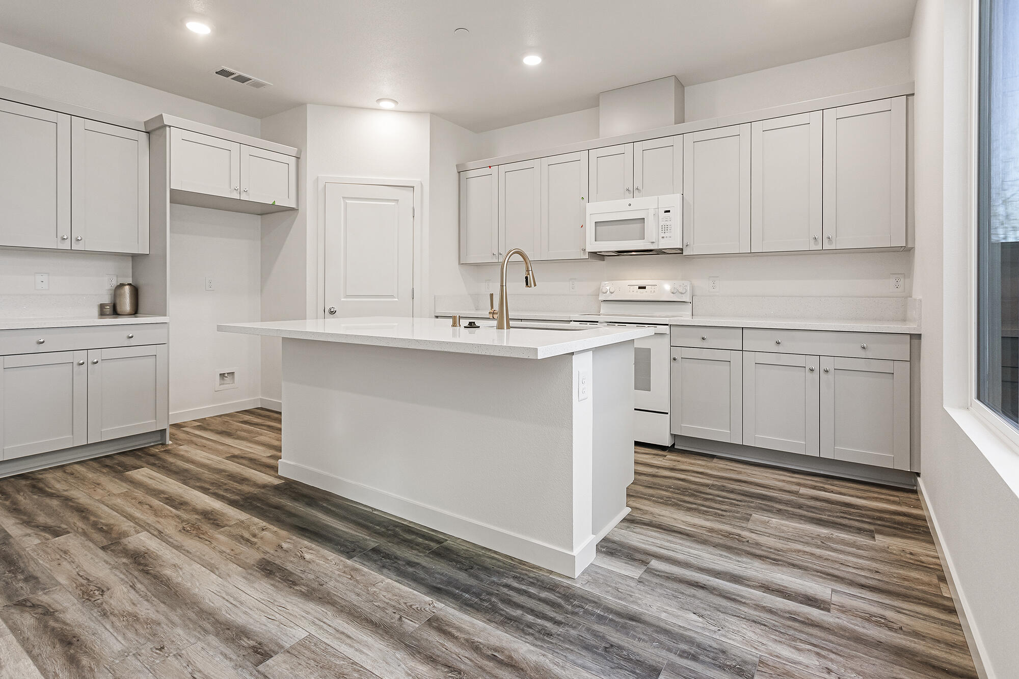 2293 Milano Trail Redding, CA 96003 - Photo 11 of 44 a kitchen with white cabinets stainless steel appliances and sink