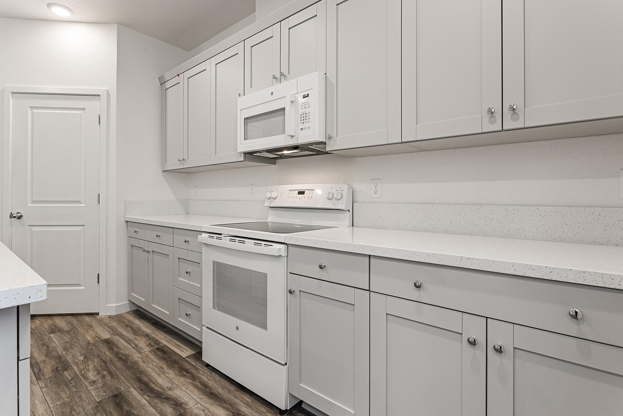 2293 Milano Trail Redding, CA 96003 - Photo 13 of 44 a kitchen with white cabinets and white appliances