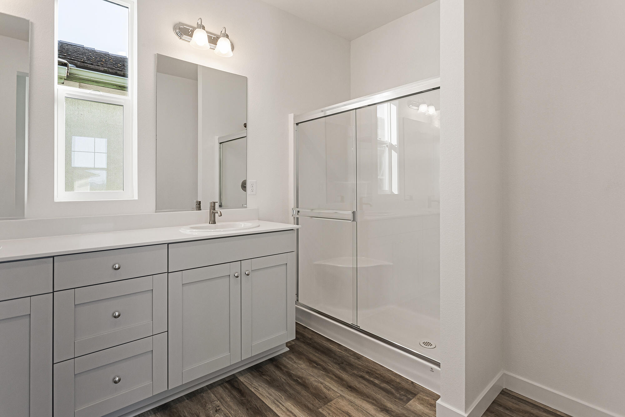 2293 Milano Trail Redding, CA 96003 - Photo 26 of 44 a bathroom with a shower sink and mirror