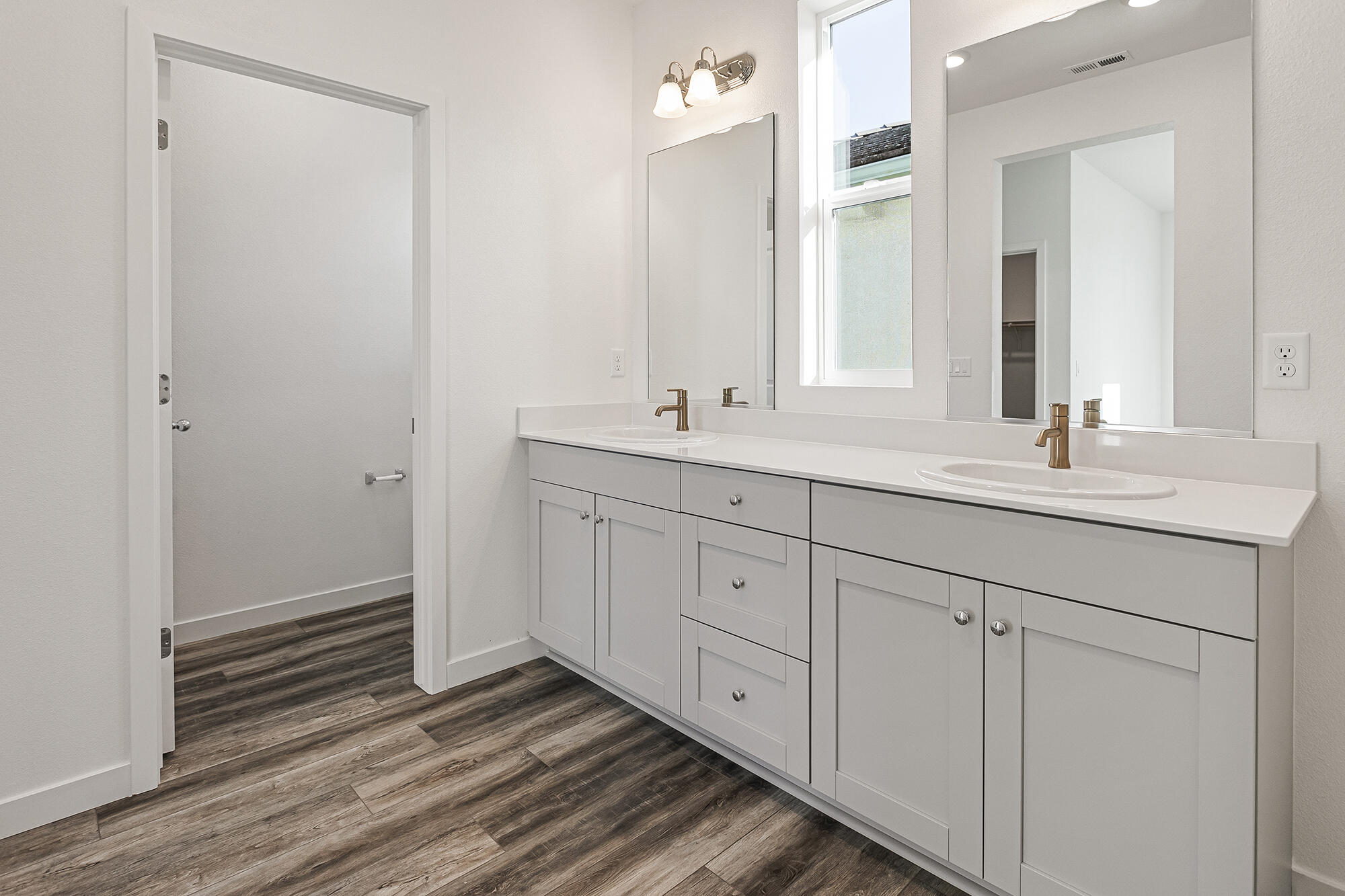 2293 Milano Trail Redding, CA 96003 - Photo 27 of 44 a bathroom with a double vanity sink and mirror