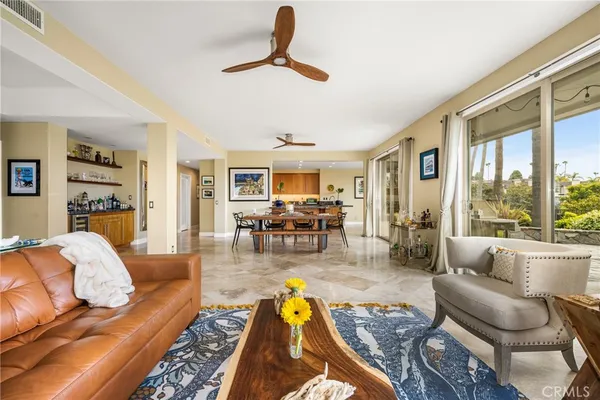 a living room with furniture a dining table and chairs