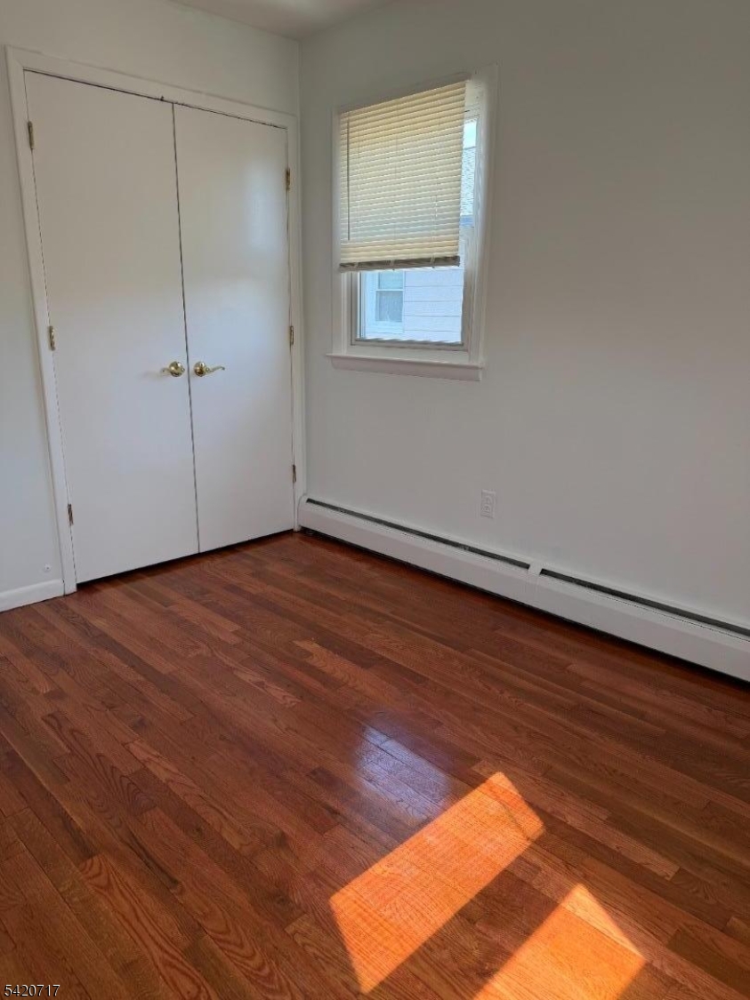 2538 Spruce Street, Unit 2 Union, NJ 07083 - Photo 15 of 29 an empty room with wooden floor and windows