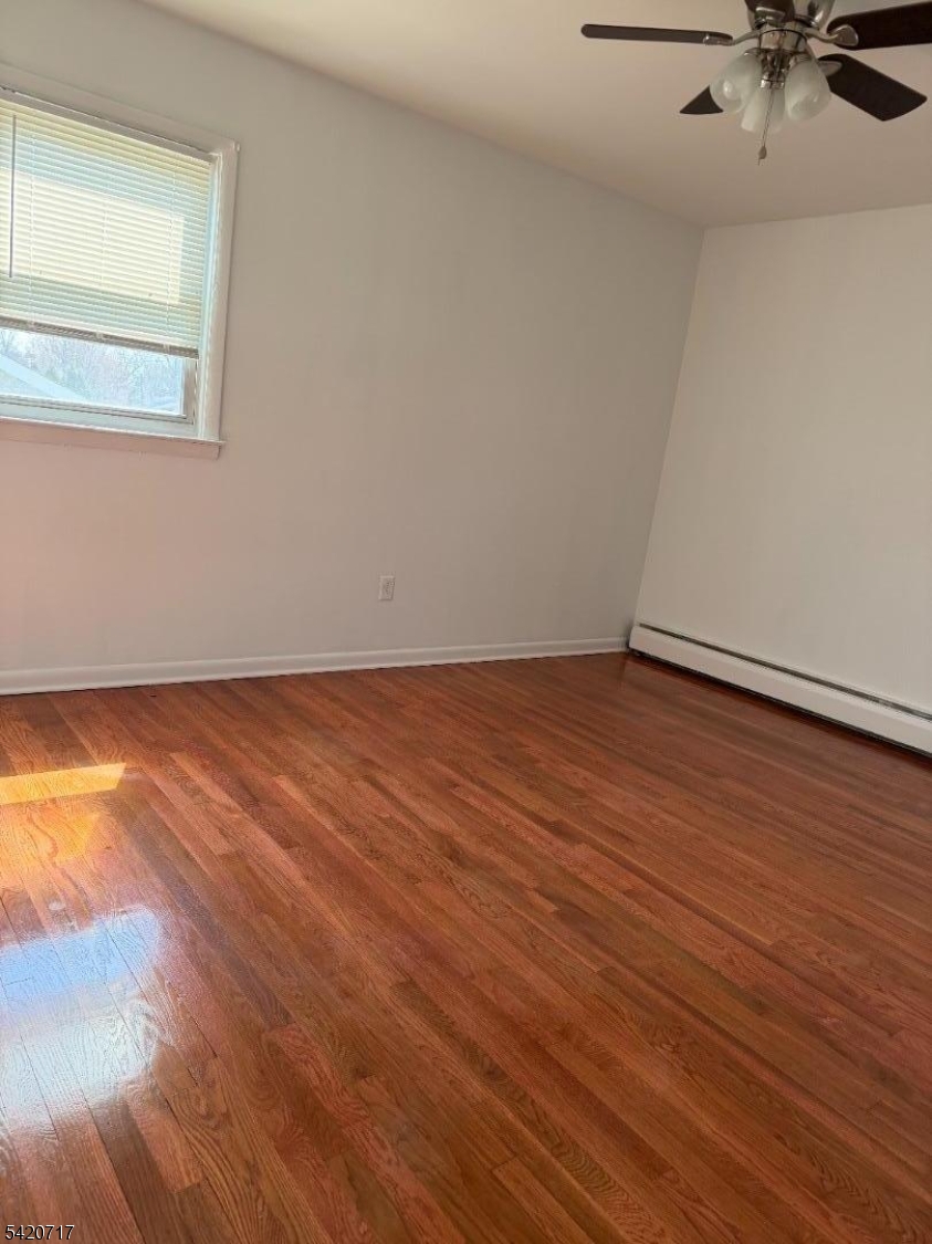 2538 Spruce Street, Unit 2 Union, NJ 07083 - Photo 16 of 29 an empty room with wooden floor and windows