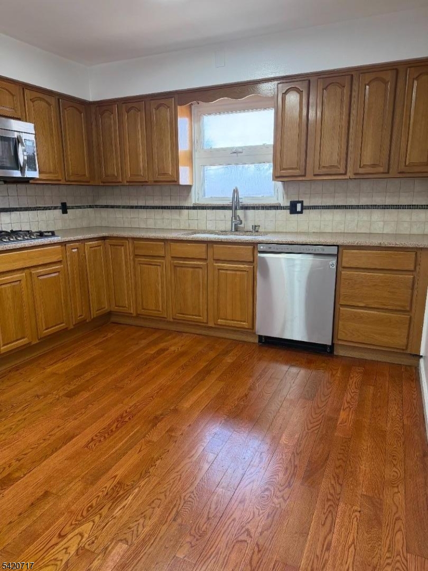 2538 Spruce Street, Unit 2 Union, NJ 07083 - Photo 2 of 29 a large kitchen with wooden floors and white cabinets