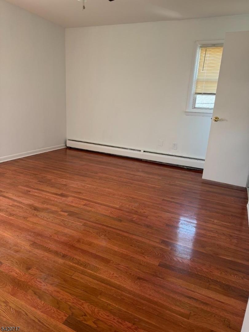 2538 Spruce Street, Unit 2 Union, NJ 07083 - Photo 21 of 29 an empty room with wooden floor and windows