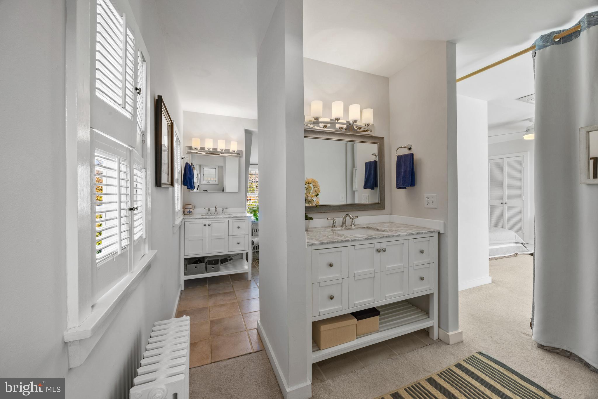 9 Shipwright Street Annapolis, MD 21401 - Photo 22 of 46 a bathroom with a double vanity sink a mirror and a shower