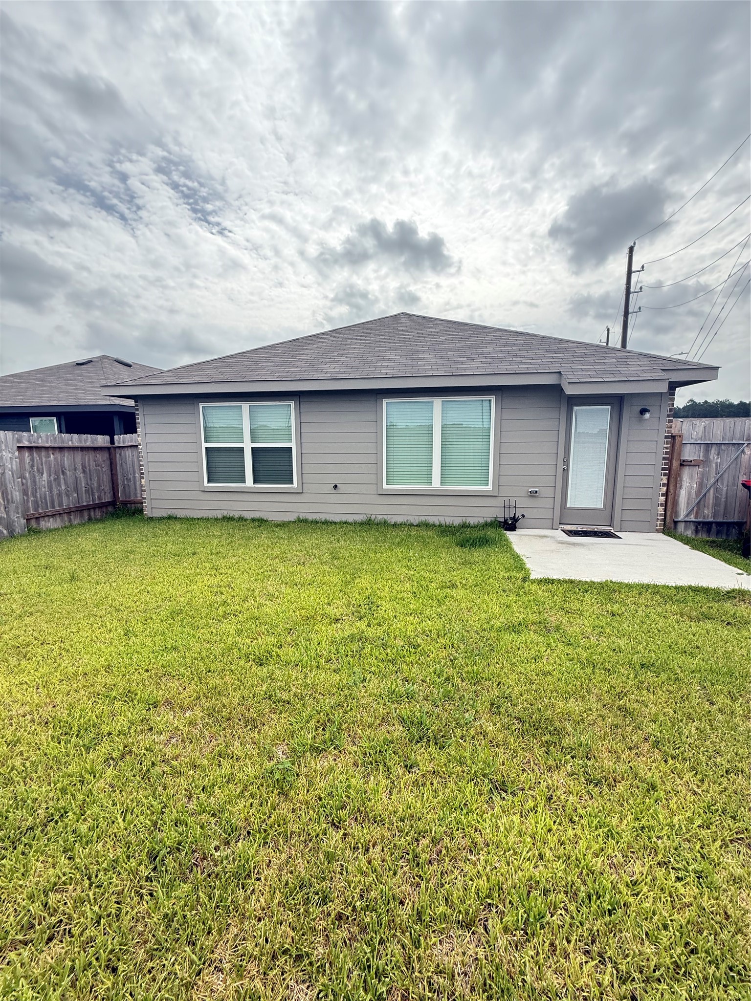 24203 Saddlestone Green Drive Spring, TX 77373 - Photo 4 of 8 a view of a house with a backyard and a garden