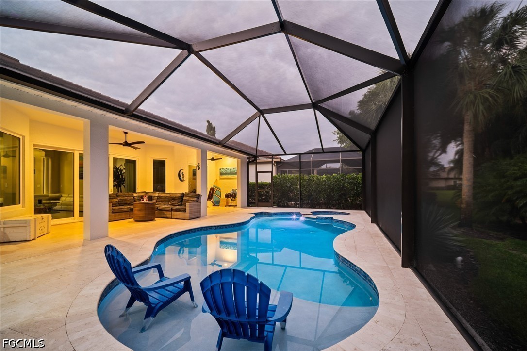 9042 Bronco Court Naples, FL 34113 - Photo 30 of 50 a view of a swimming pool with a lounge chairs