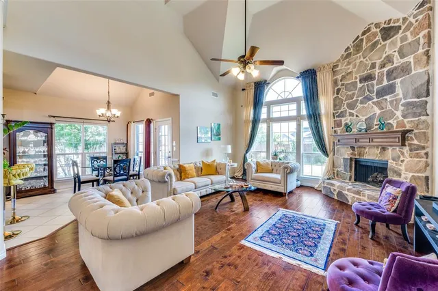 a living room with furniture a fireplace and a chandelier