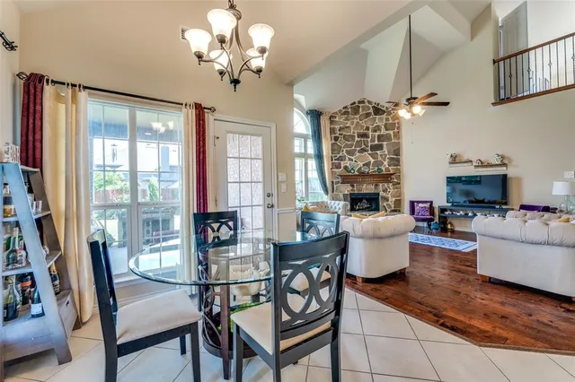a dining room with furniture a chandelier and window