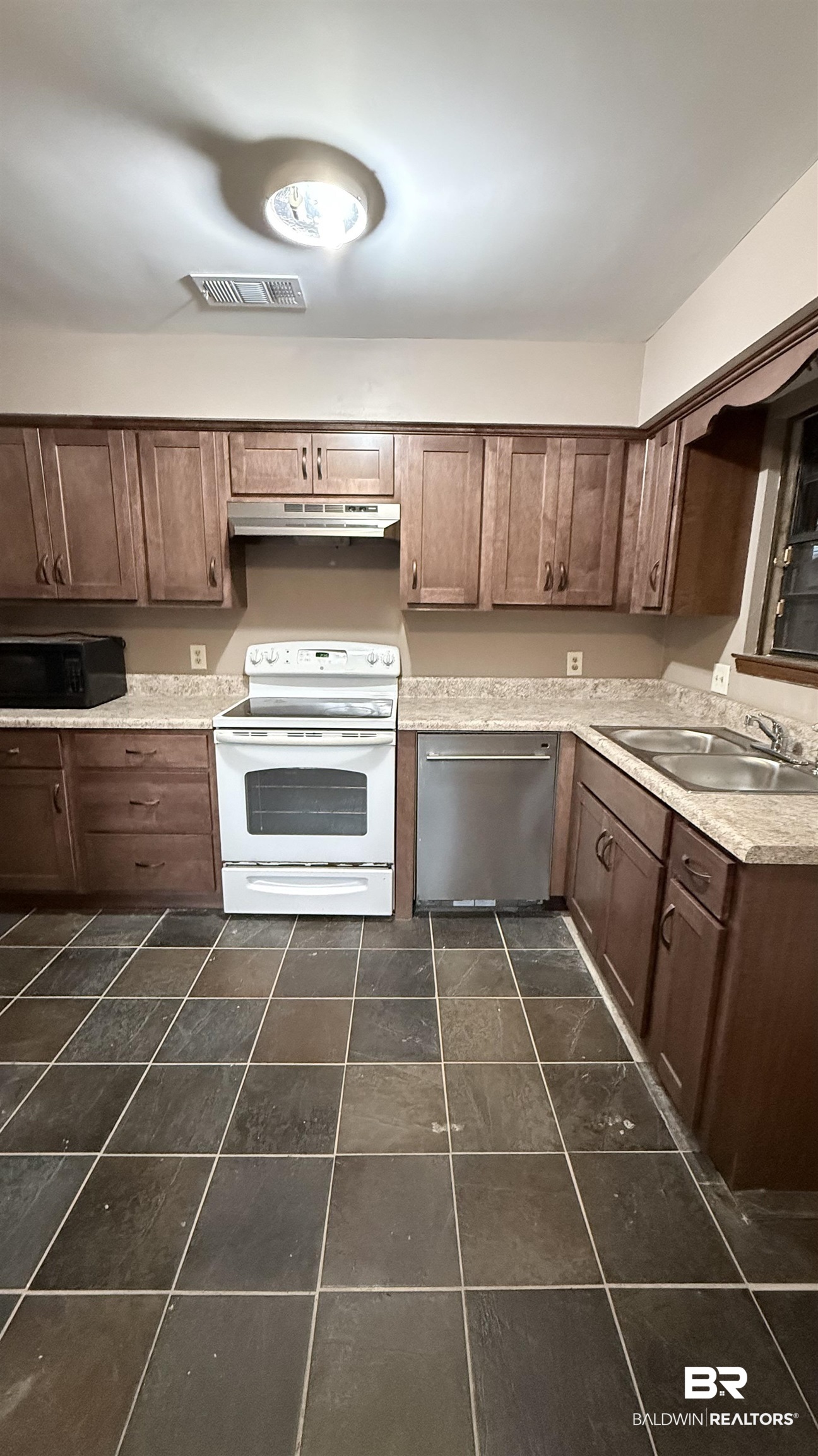 4131 Springdale Road Mobile, AL 36609 - Photo 5 of 28 Kitchen featuring light countertops, white electric range, stainless steel dishwasher, and dark brown cabinets
