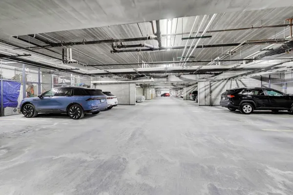 a view of parking garage with cars